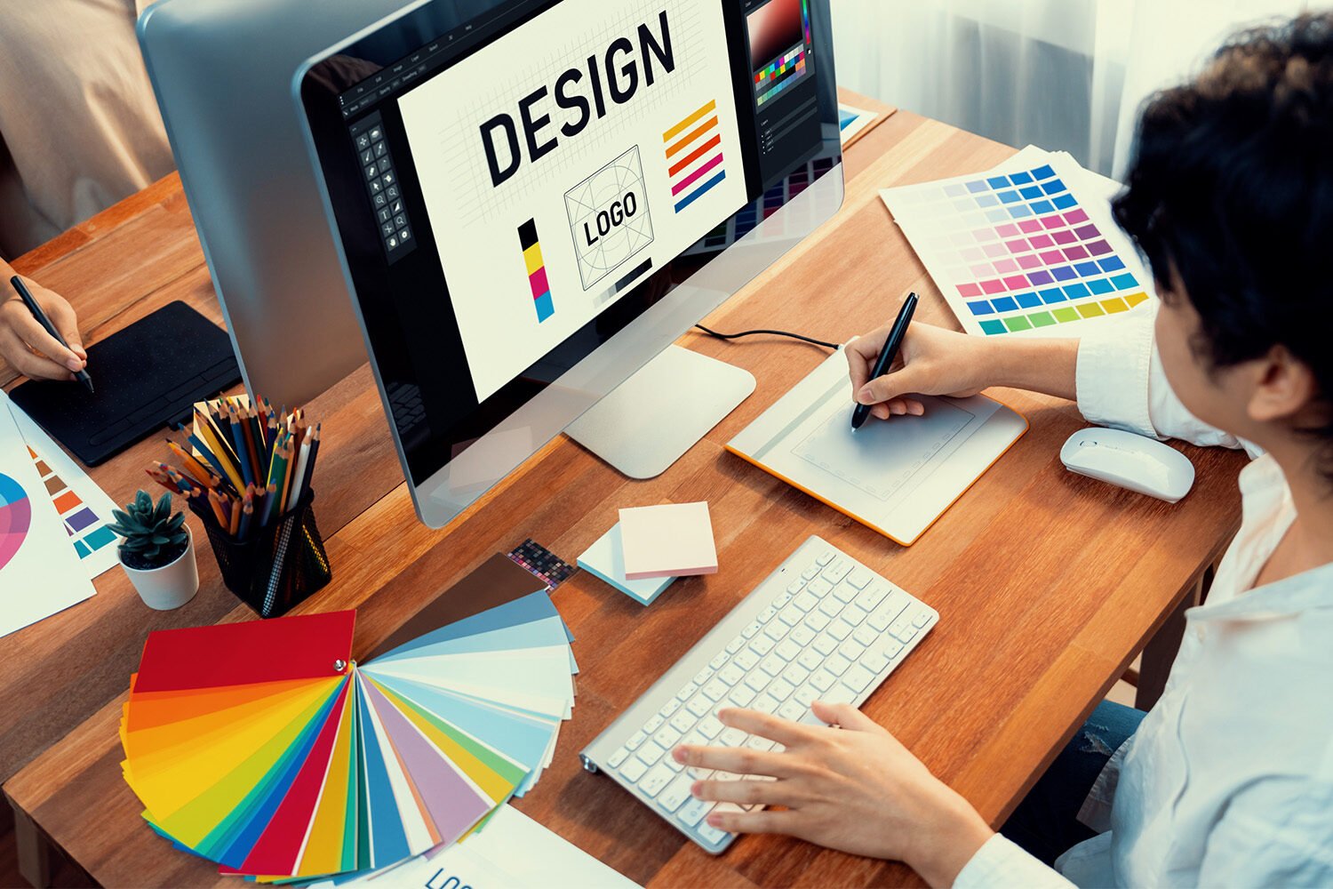 graphic-designer-works-computer-laptop-with-digital-pen-scrutinize